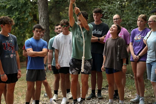 A man swinging on a rope.